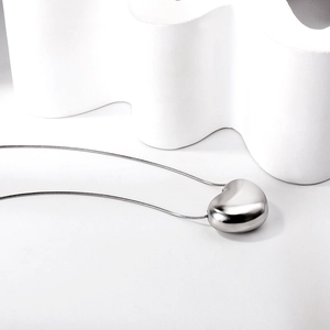 Polished 3D heart pendant necklace with minimalist snake chain on white background