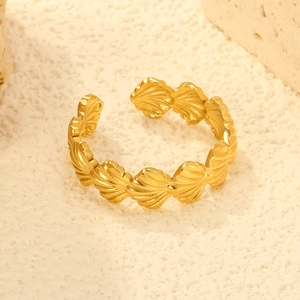 18K gold plated stainless steel open ring with shell design on textured stone background
