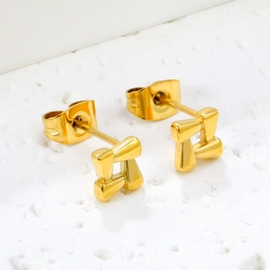 Minimalist gold square geometric hollow stud earrings for women on white stone texture