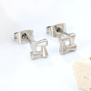 Detail view of silver hollow geometric square earrings with a butterfly backing