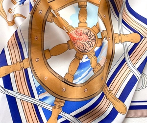 Macro detail of nautical silk scarf featuring vintage ship helm and anchor patterns