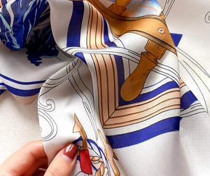 Close-up of silk scarf fabric showing high-quality nautical wheel and anchor print