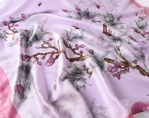 Close-up of lavender silk scarf featuring elegant magnolia floral print and satin texture