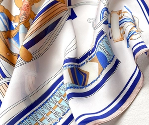 Detail of silk square scarf showing nautical print with anchor and hand-rolled pink edges