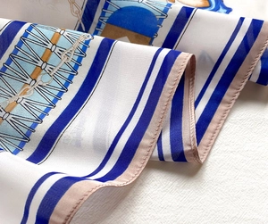 Close-up of nautical stripe silk scarf showing detailed stitching and satin fabric texture