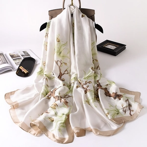 Elegant white silk scarf with green magnolia floral print and golden satin border trim