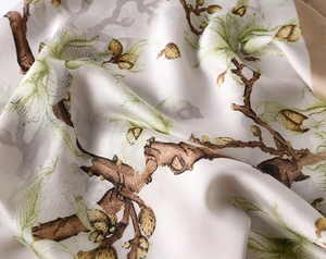 Detailed view of silky magnolia print fabric with elegant floral pattern and soft drape