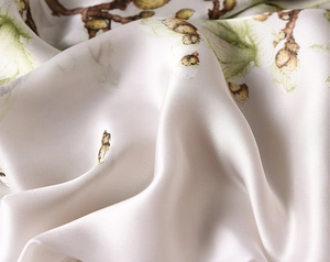 Macro view of luxurious silk scarf fabric with elegant magnolia flower print detail