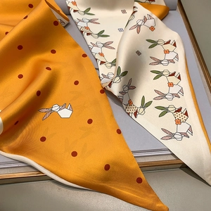 Detail of satin long scarf with rabbit prints and premium rolled edges in a gift box