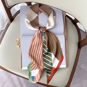 Detailed view of long silk scarf showing houndstooth patterns and 100% silk label