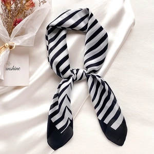 Elegant black and white striped narrow silk scarf for women in a chic knotted style