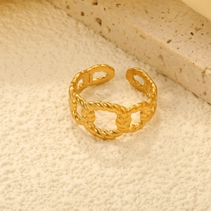 Irregular twisted gold open ring in stainless steel with textured woven pattern finish