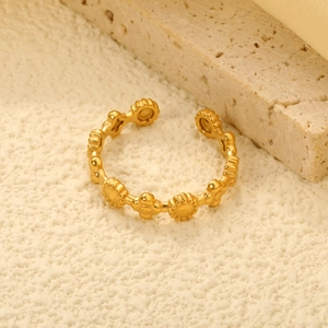 Detailed macro view of the gold open ring featuring hollow sunflower and bead patterns