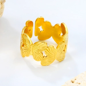 Detailed view of the golden butterfly open ring with intricate floral engraving