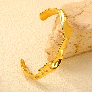 Irregular 18K gold plated stainless steel open bangle with organic lava texture finish