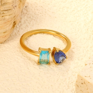 Detail of snake style ring with blue heart and rectangular zircon on stone
