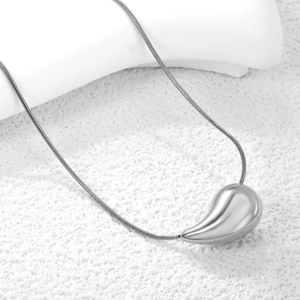 Minimalist silver water drop pendant on a thin snake chain necklace for women