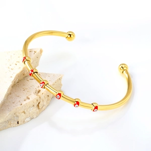 Bracelet jonc doré ouvert avec motifs œil protecteur émaillés rouges et blancs sur pierre