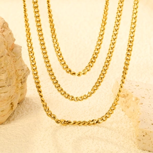 Close-up of triple layered 18K gold plated stainless steel curb chain necklaces