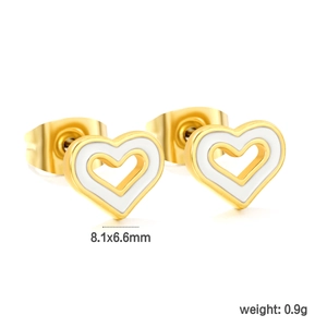 Macro view of hollow double-layer heart earrings with white enamel and golden finish