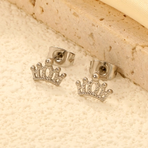 Minimalist crown stud earrings in silver stainless steel shown on textured background