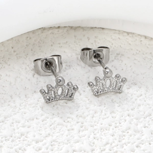 Macro shot of silver crown stud earrings with detailed cutout design and butterfly back