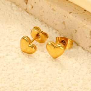 Polished 18K gold plated stainless steel heart stud earrings on a stone surface