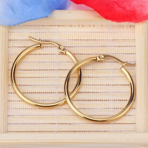 Detail of 2mm gold hoop earrings showing mirror-polished finish and secure hinged closure