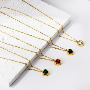 Golden heart pendant necklaces with vibrant red, green, black and white gemstones