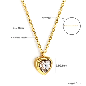 Detail of heart pendant necklace with gold plated stainless steel and clear crystal