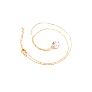 Close-up of golden necklace featuring a round white zircon pendant and lobster clasp