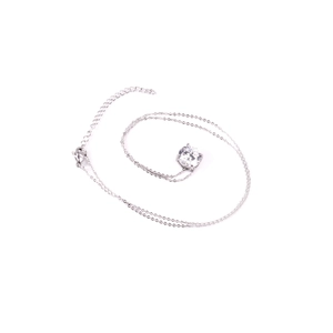 Detail of minimalist lobster clasp and adjustable silver chain with a round zircon stone