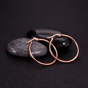 Polished rose gold 2mm stainless steel hoop earrings on decorative black stones