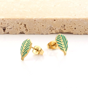 Golden stainless steel tropical leaf stud earrings with green enamel on a stone base