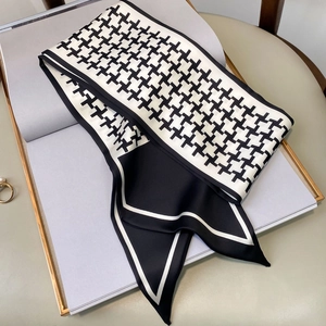 Detail of silk scarf with black and white geometric pattern on a fashion book