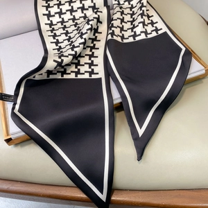 Detail of long houndstooth silk-feel scarf with black and white satin texture