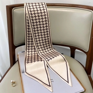 Elegant houndstooth silk scarf twilly for women tied on a leather and wood chair