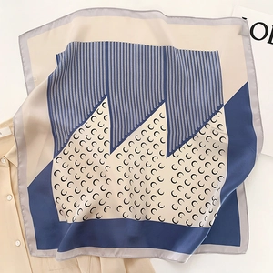 Detail of silk square scarf featuring geometric V-stripes and crescent moon patterns