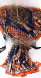 Detailed macro view of orange and blue tree of life print silk scarf with fine stitching