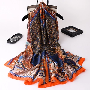 Detailed close-up of vibrant floral satin shawl with luxury bohemian patterns and silk luster