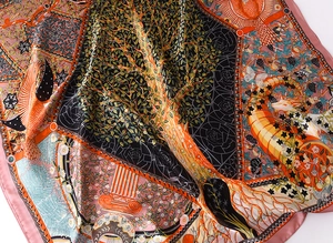 Detailed view of satin silk scarf featuring tree of life and bird illustration prints