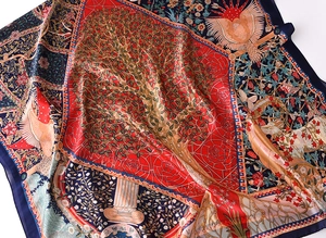 Detailed close-up of retro silk scarf featuring vintage art prints and satin texture