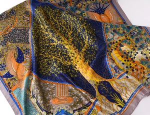 Detail of silk scarf showing artistic gold tree pattern and vibrant mythological elements