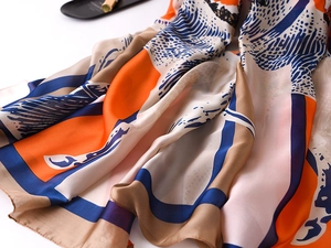 Macro shot of silk-like scarf material showing soft texture and geometric wave pattern