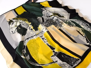 Detail of silk scarf with equestrian horse and floral print showing soft fabric texture