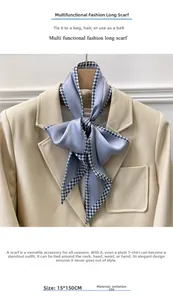 Detail of 15x150cm blue-grey houndstooth silk scarf tied on a beige blazer jacket