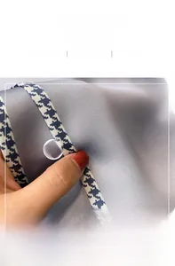 Macro shot of breathable silk scarf with grey center and houndstooth pattern edges