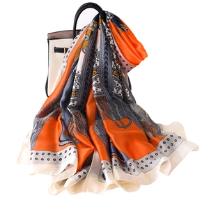 Silk-like satin scarf with saddle chain print draped on handbag for beach sun protection