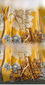 Detail of yellow silk scarf showing vibrant peony patterns and precise hemmed edges