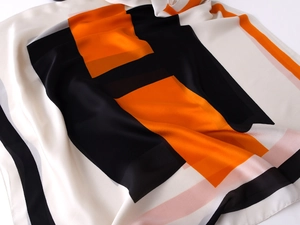 Close-up of lightweight silk scarf featuring modern geometric color block design